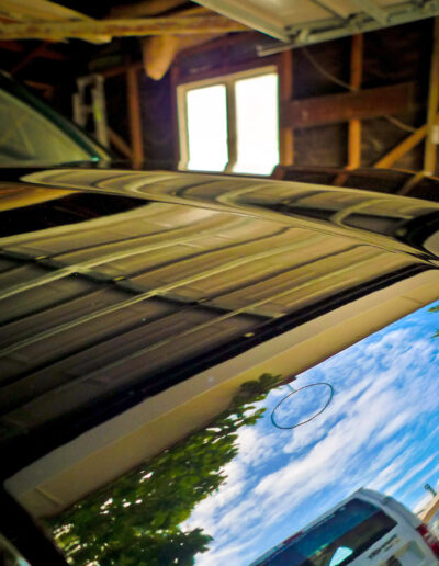 Reflections on bonnet of roof trees and sky after detailing